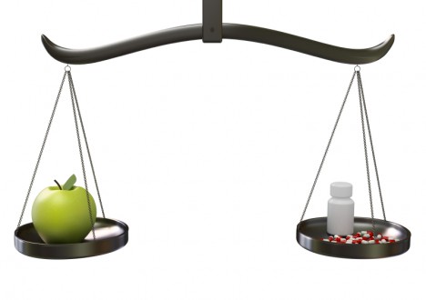 Scale balancing fruit and medicine